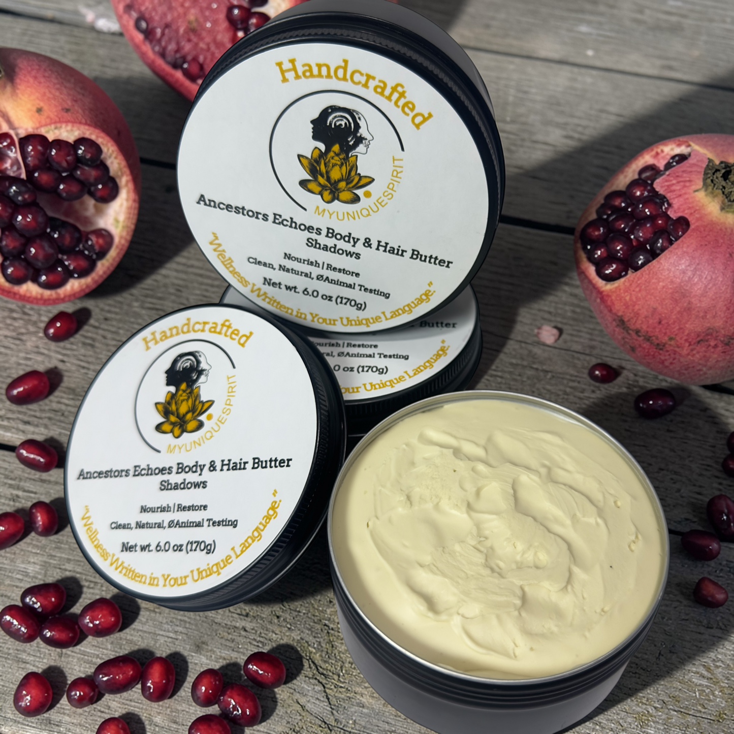 Handcrafted body and hair butter with pomegranate seeds on a wooden surface