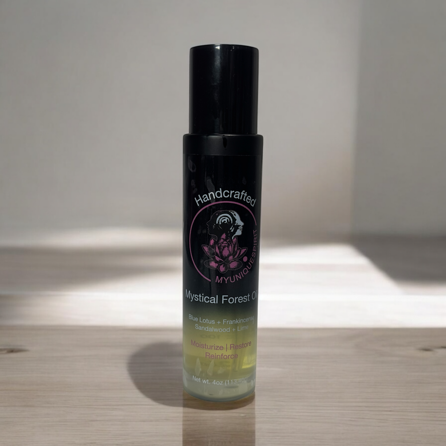 Handcrafted Botanicals body oil with black caps and labels featuring floral graphics. The bottles are displayed against a white background.