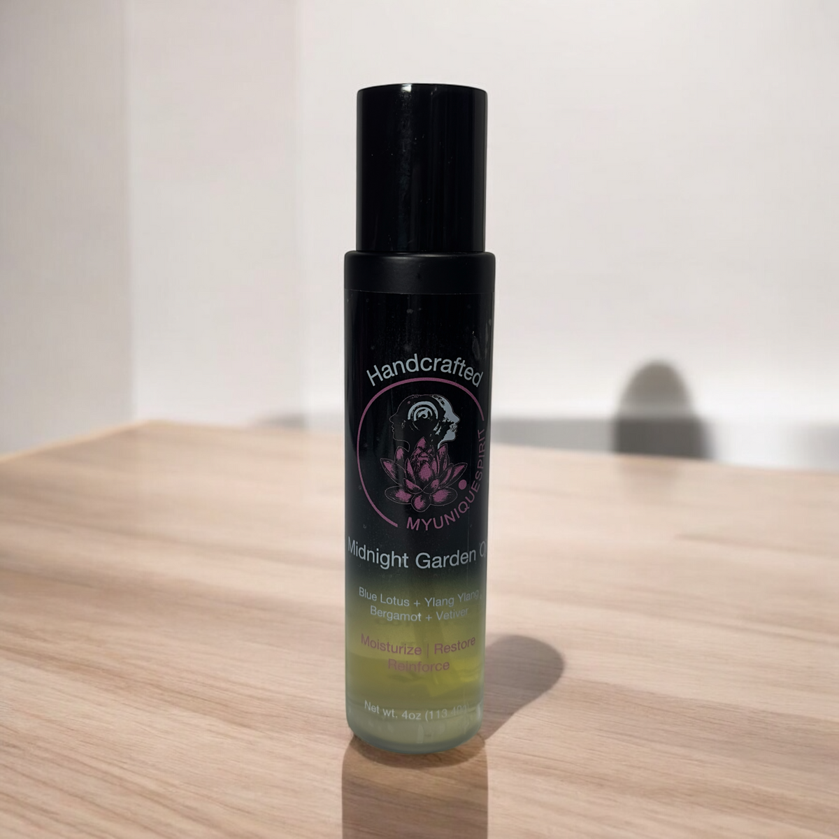 Handcrafted Botanicals body oil with black caps and labels featuring floral graphics. The bottles are displayed against a white background.