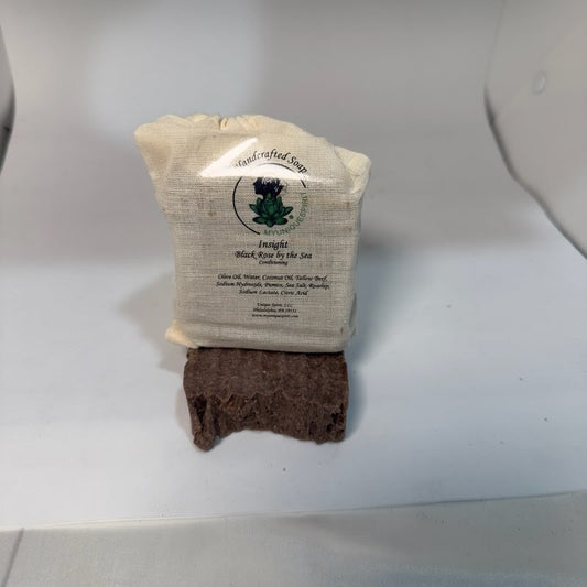 Bar of handcrafted soap on a white backdrop with the My Unique Spirit logo
