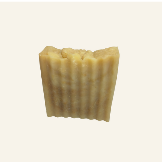 Bar of soap with a ribbed texture on a white background