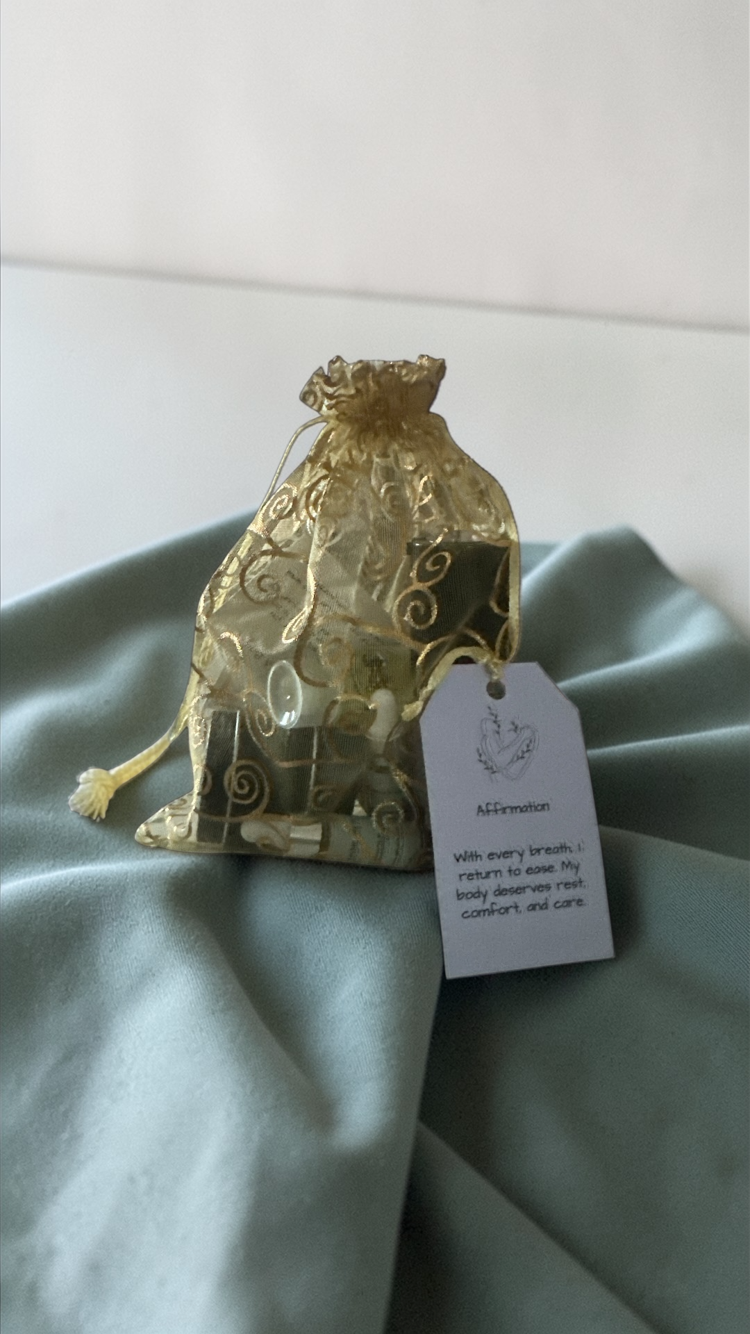 Organza bag that holds mini size skincare products and affirmation 