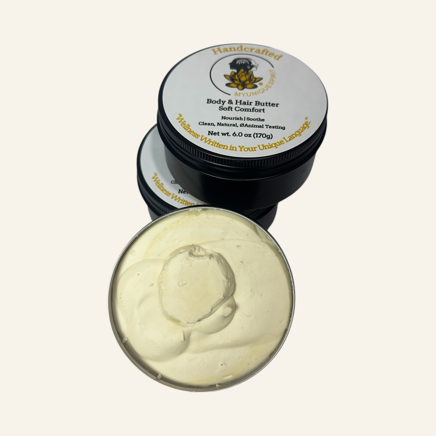 Two containers of Soft Comfort body and hair butter with a visible brand logo on a cream background